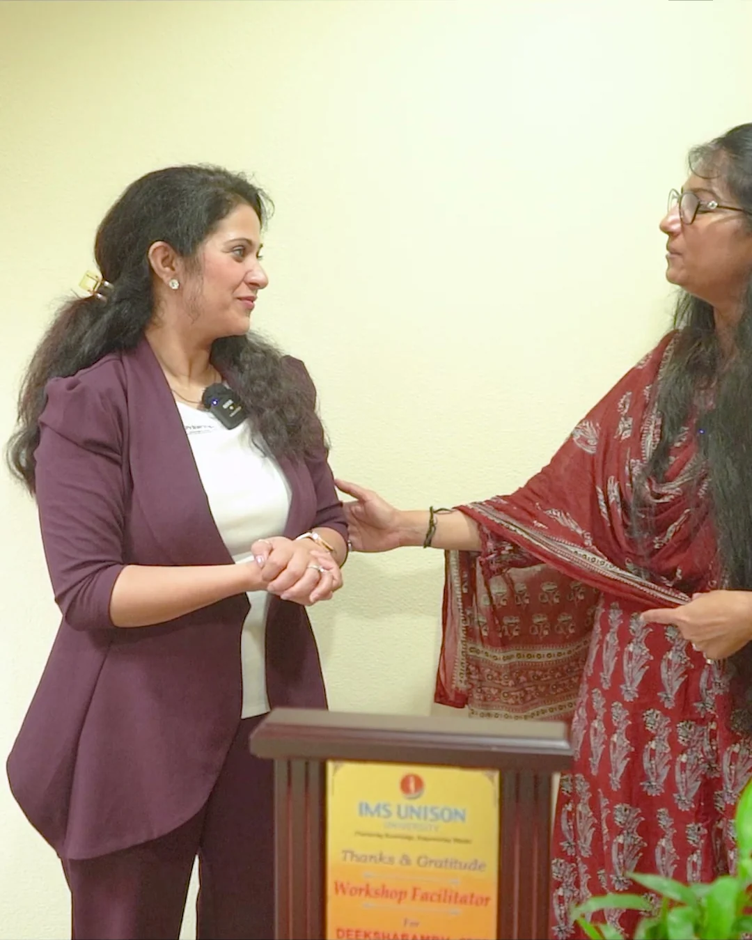 Charu Wadhwa being felicitated with a shawl at the podium after a seminar